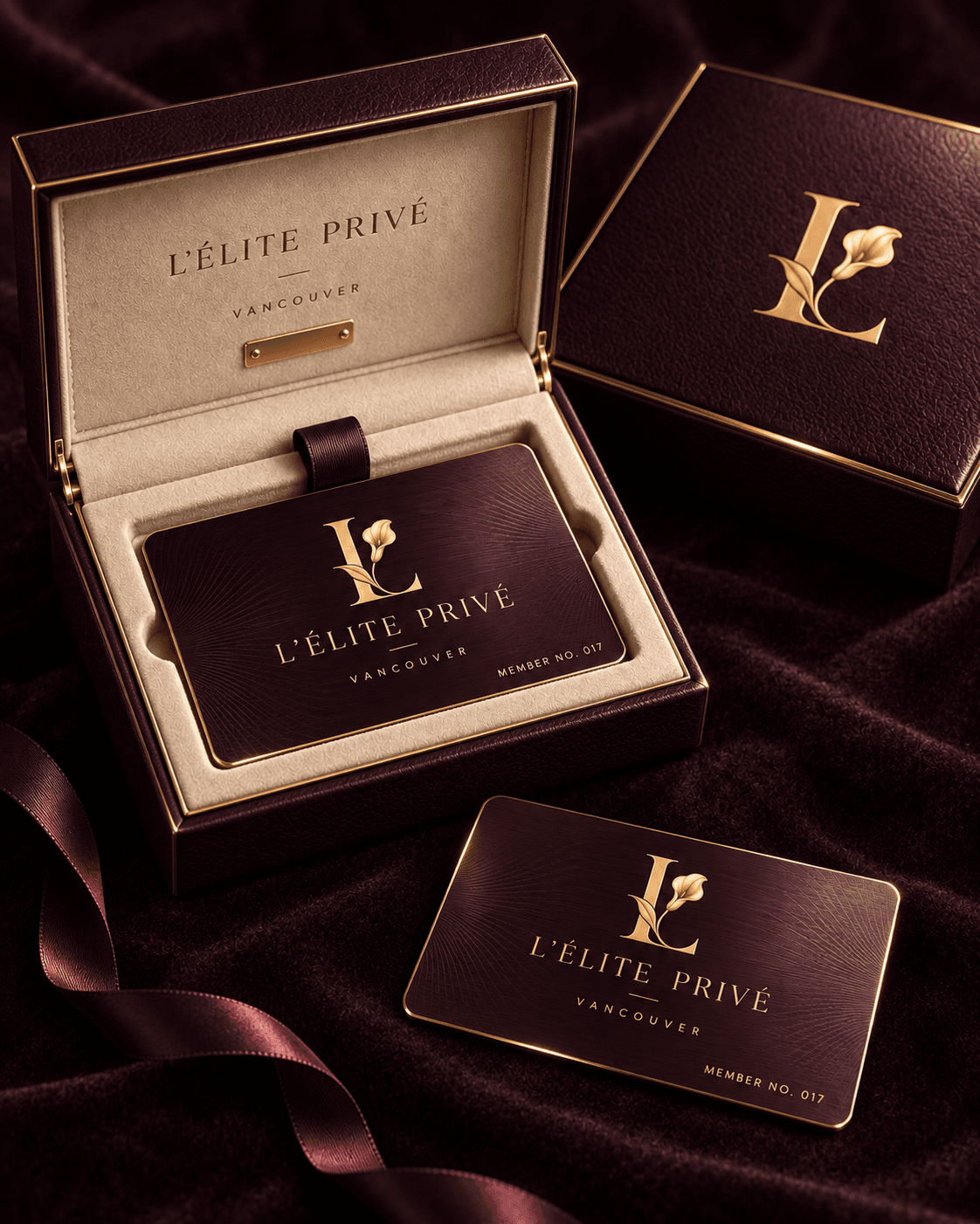 L’Élite Privé aubergine and gold membership cards in an ivory-lined presentation case